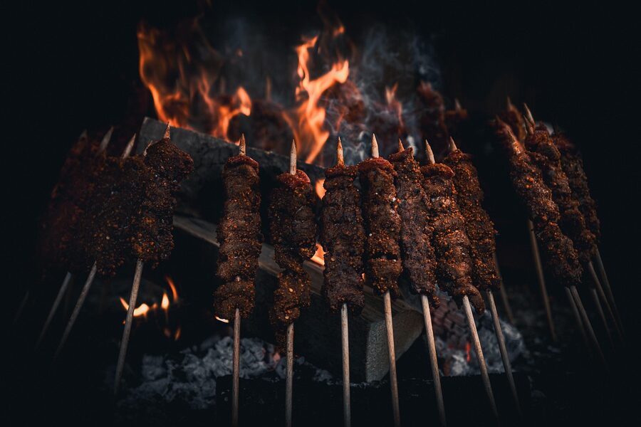 BBQ grill with food cooking on a boat