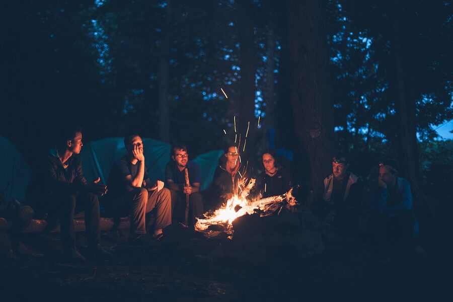 Campfire bonfire burning at night during desert camping experience