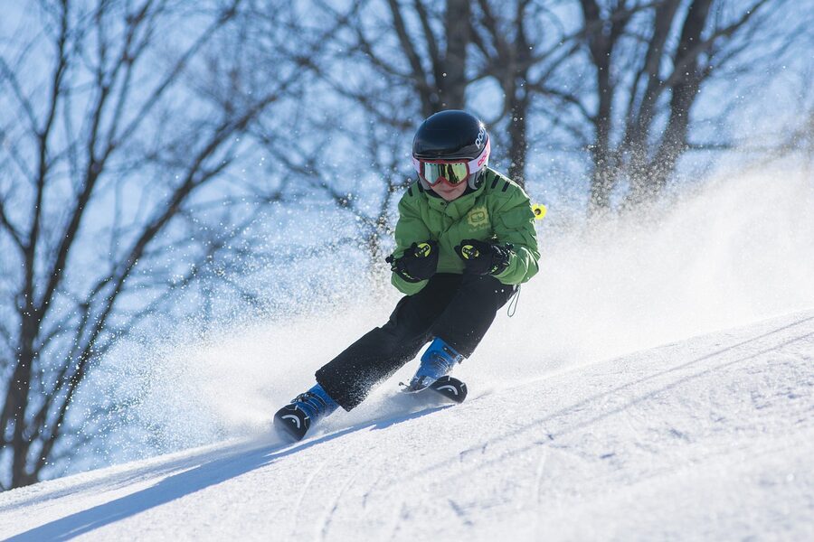 Boy wearing ski goggles in snowy winter setting