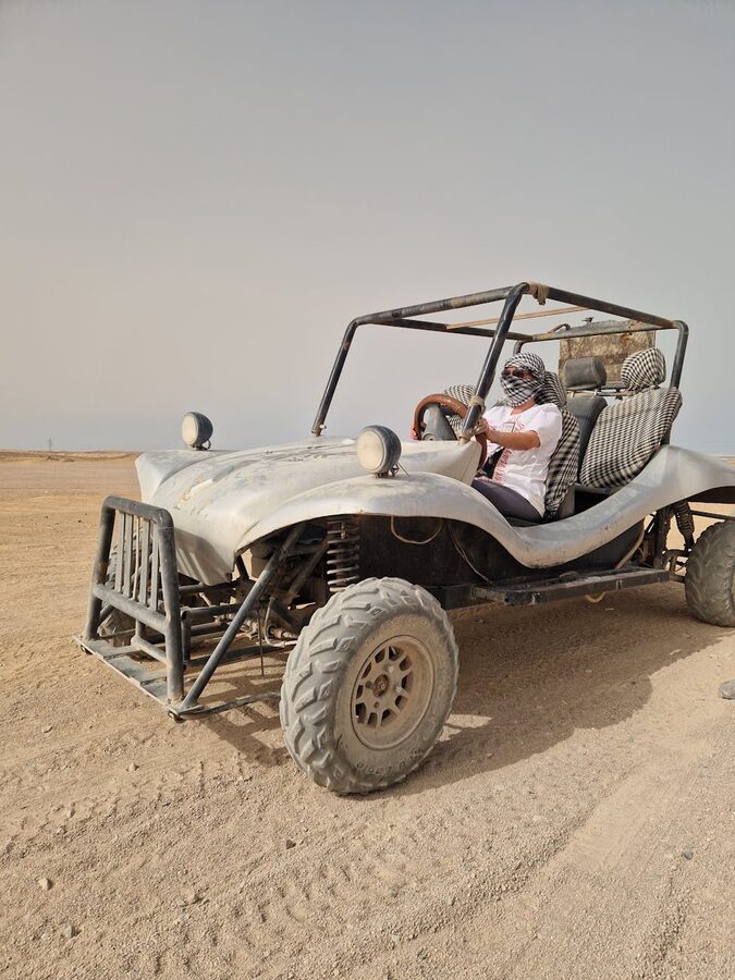 Driving off-road buggy in sunny desert