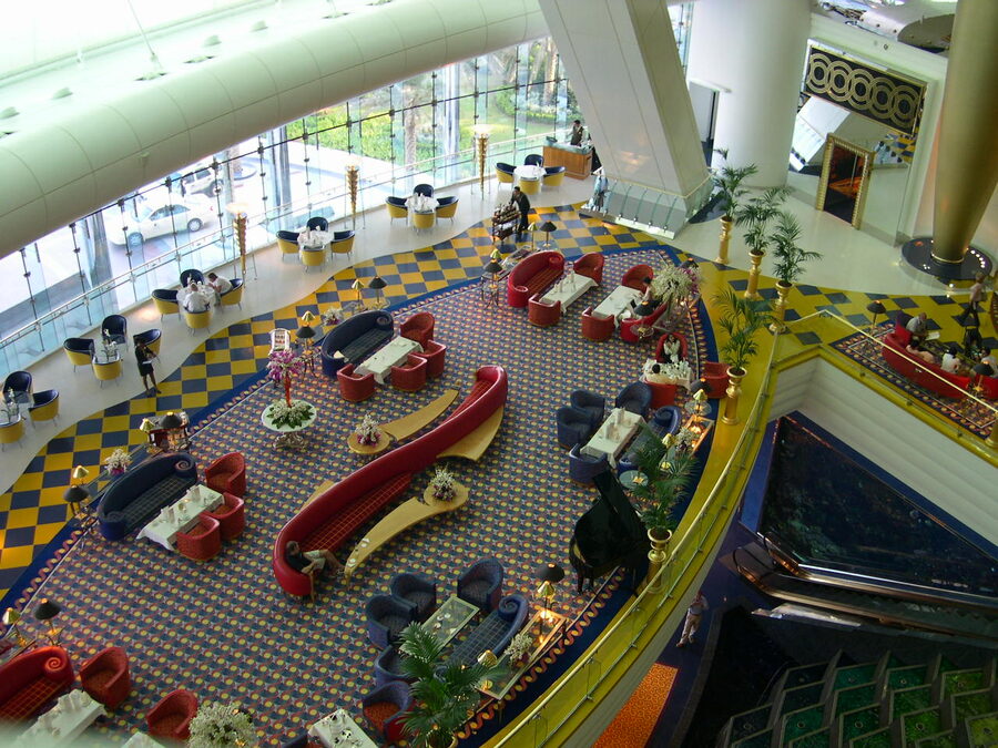 Burj Al Arab interior atrium with towering gold columns and fountain
