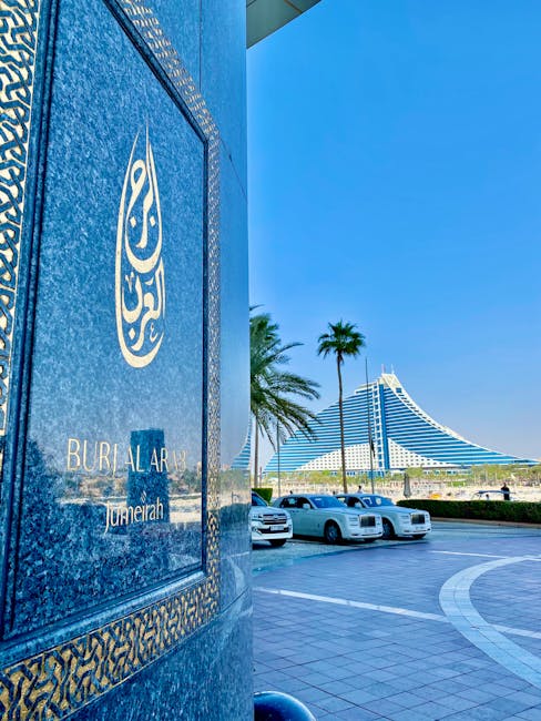 Luxury cars and palm trees at the entrance of Burj Al Arab