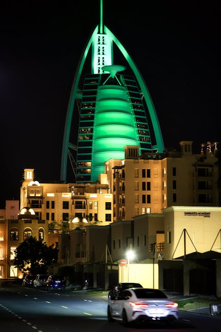 Burj Al Arab illuminated at night with LED facade against dark sky