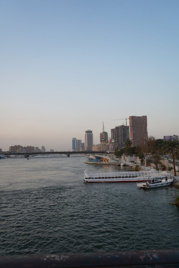 Cairo skyline with boats on the Nile at dusk