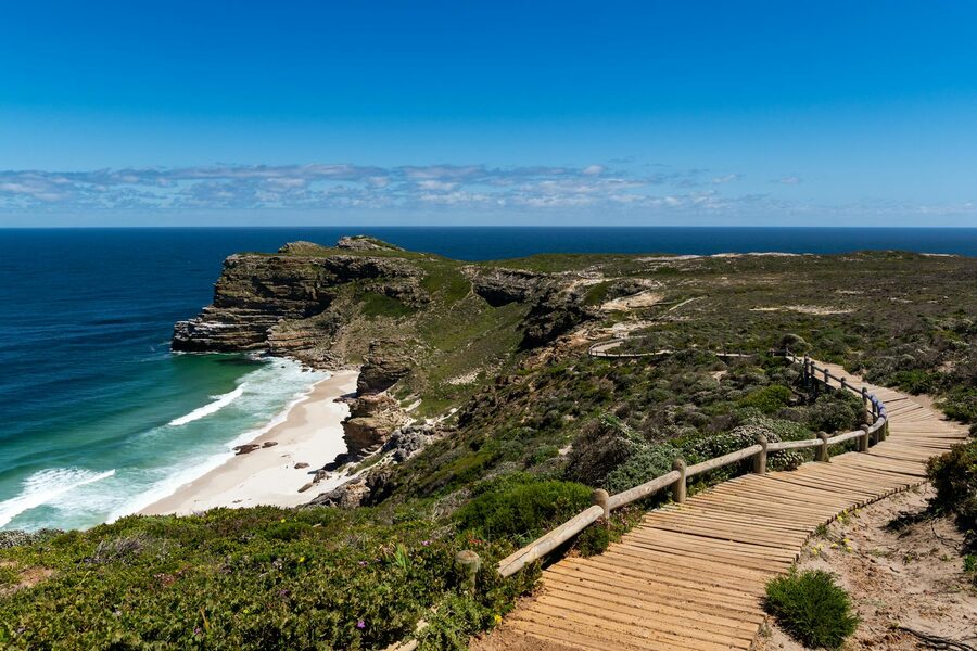 Wooden pathway with cliffs and ocean at Cape Point