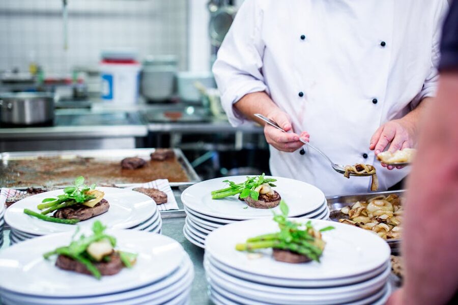 Chef preparing gourmet dishes in professional kitchen