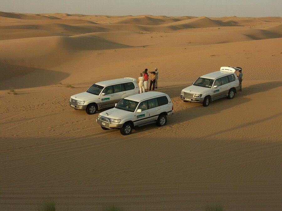 ATV quad bikes lined up in the desert sand ready for safari tour
