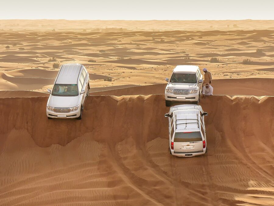 Desert adventure vehicle stuck in sand dunes during a safari tour