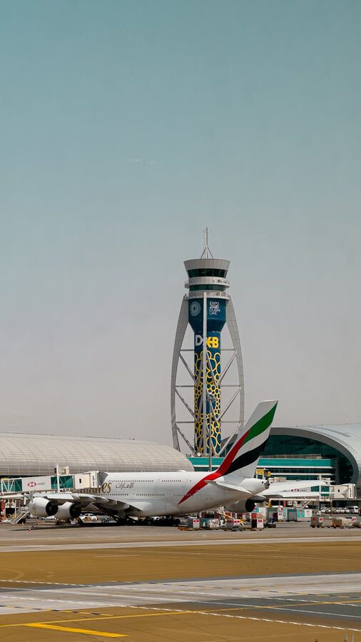 Emirates airplane at Dubai Airport with ATC tower