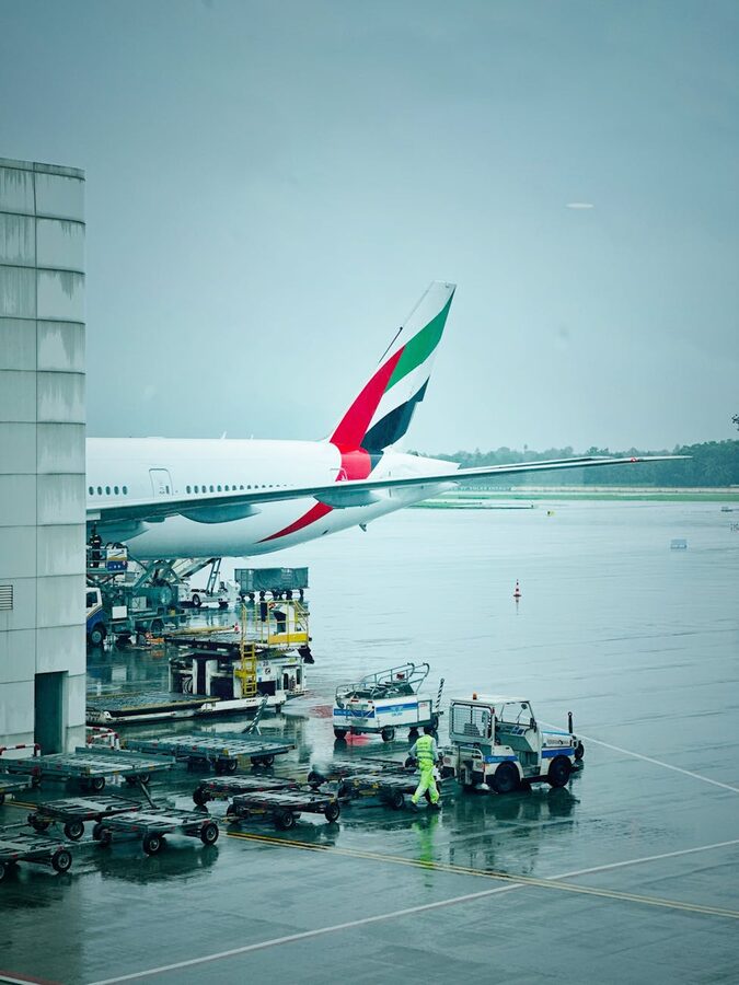 Passenger jet at Dubai Airport tarmac in rainy weather