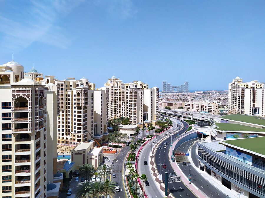 Modern Dubai Downtown street with skyscrapers and palm trees