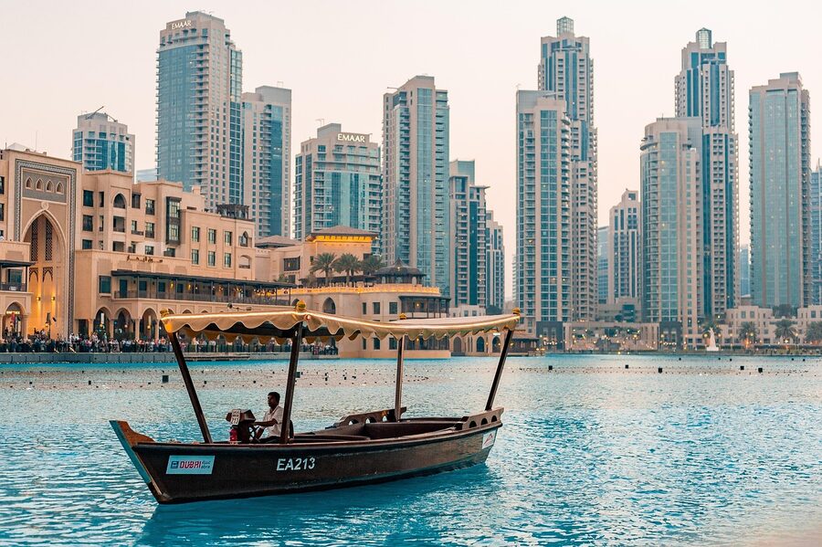 People walking near Dubai Downtown at sunset with the Burj Khalifa in the background