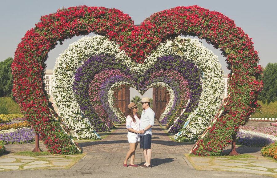 Couple at heart-shaped arch Dubai Miracle Garden