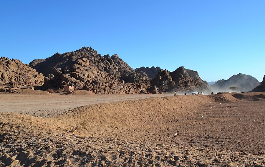 Dust cloud rising from desert driving