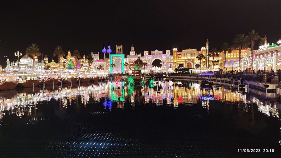 Global Village Dubai at night with illuminated pavilions