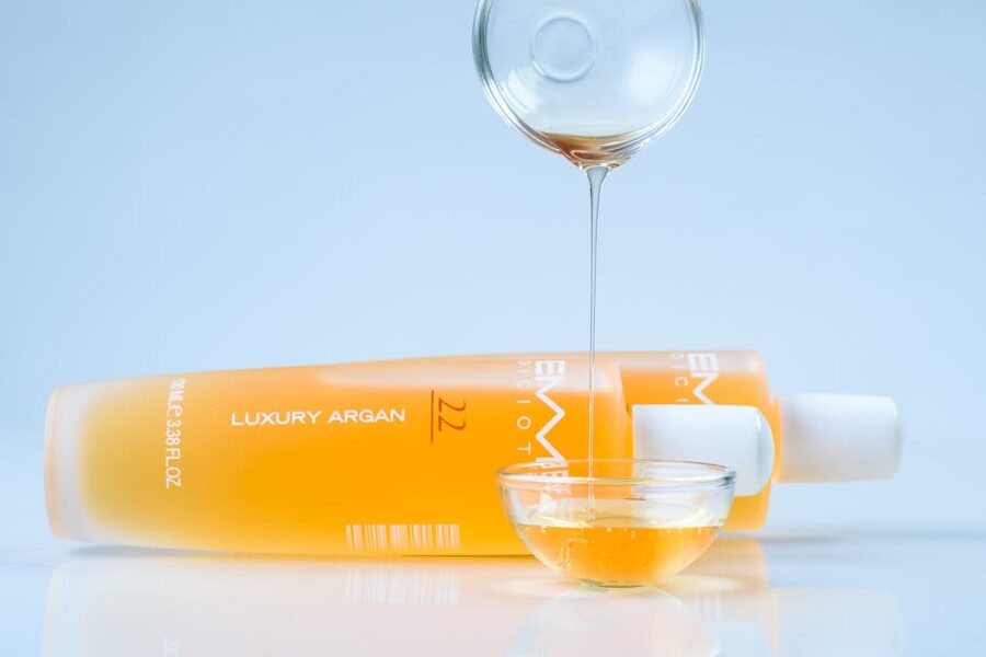 Argan oil pouring into glass bowl
