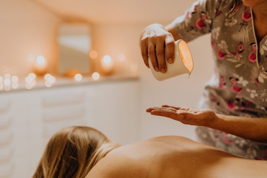 Professional therapist pouring oil
