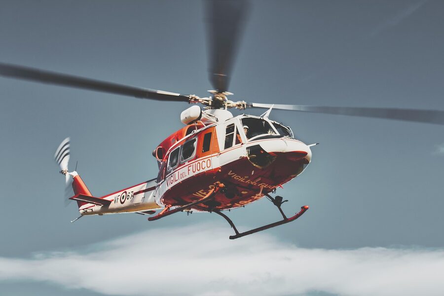 Passenger looking through helicopter window during flight