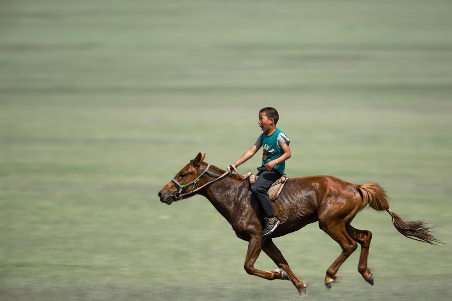 Boy horse riding galloping