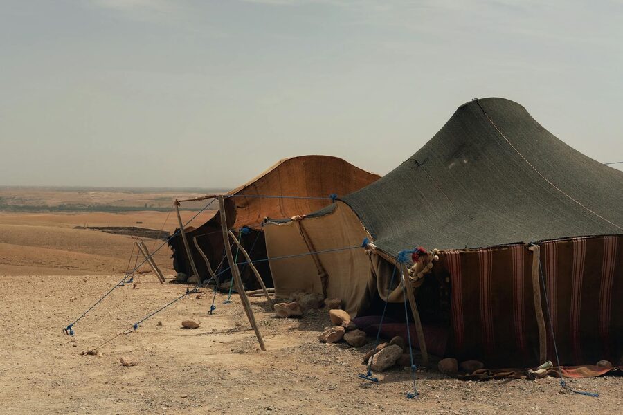 Traditional Bedouin tents under a clear sky