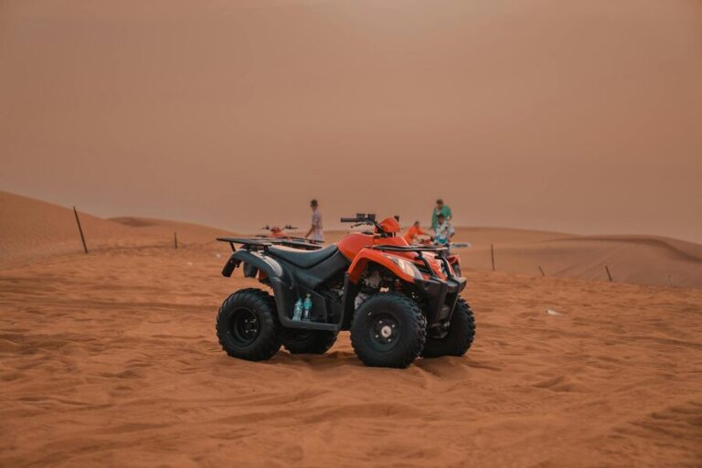 Quad biking across desert sand dunes