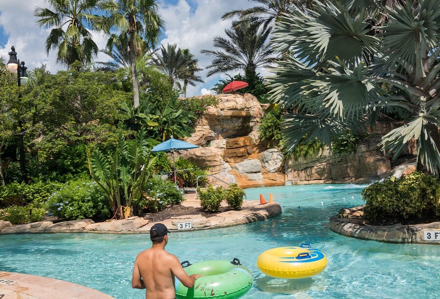 Lazy river winding through water park with inner tubes
