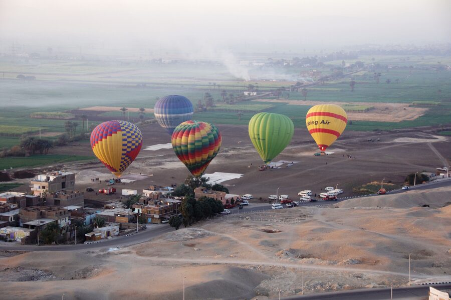 Fleet of hot air balloons over Luxor desert at sunrise