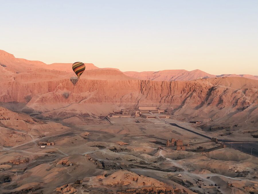 Hot air balloon floating near Hatshepsut Temple in Luxor Egypt