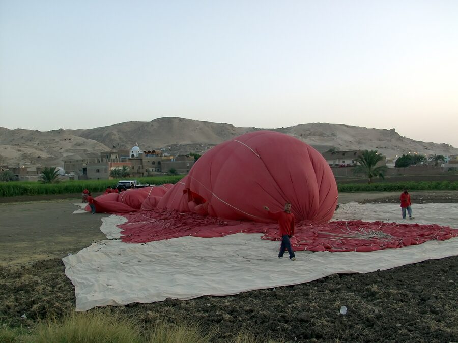 Hot air balloon preparing for takeoff on Luxor West Bank in early morning