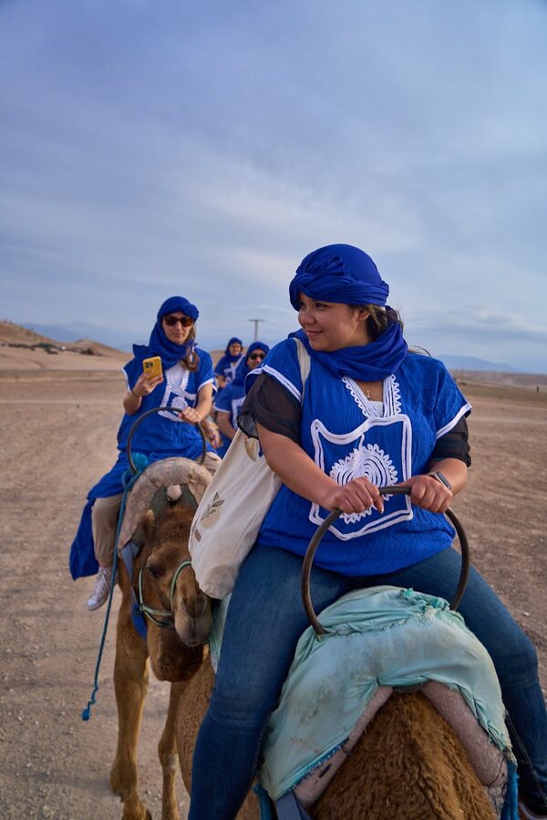 Group camel ride in Moroccan desert