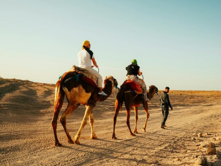 Tourists riding camels in Moroccan desert