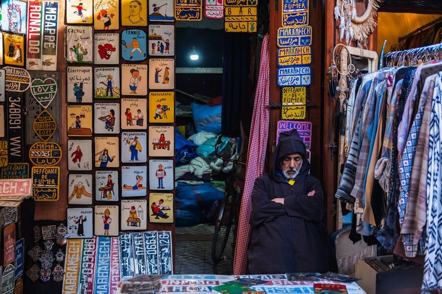 Marrakech souk vendor with signs