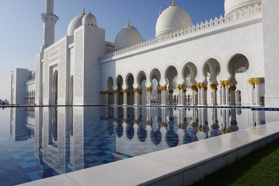 Grand mosque reflected in water pool with perfect symmetry