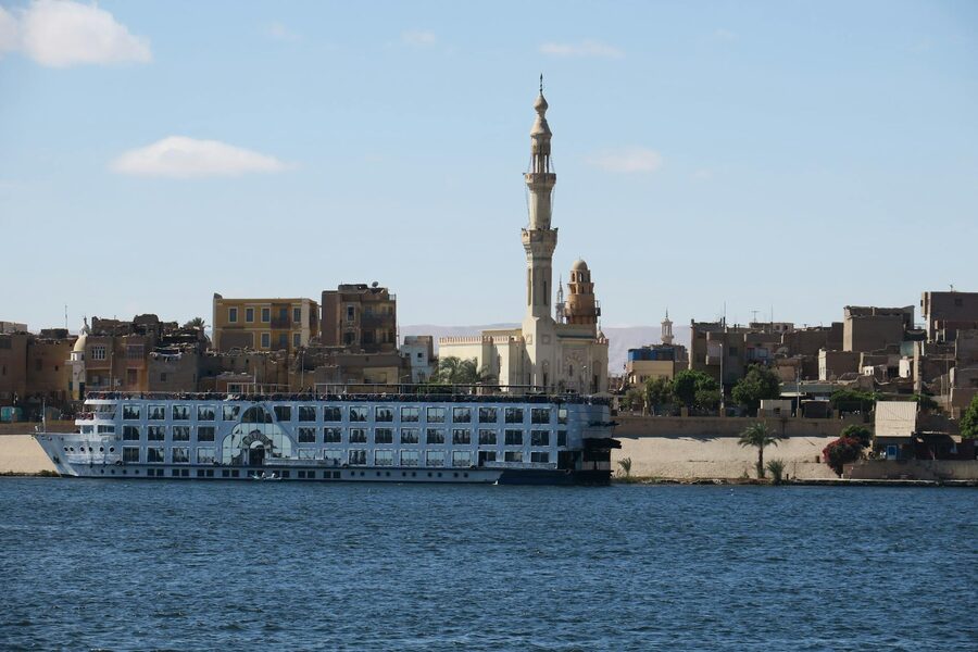 Cruise ship on the Nile near a mosque in Aswan