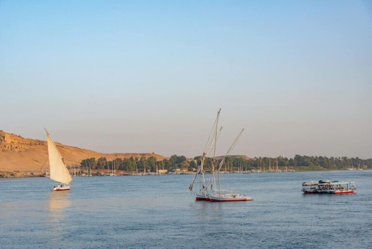 Classic sailboats on the Nile with Aswan desert backdrop