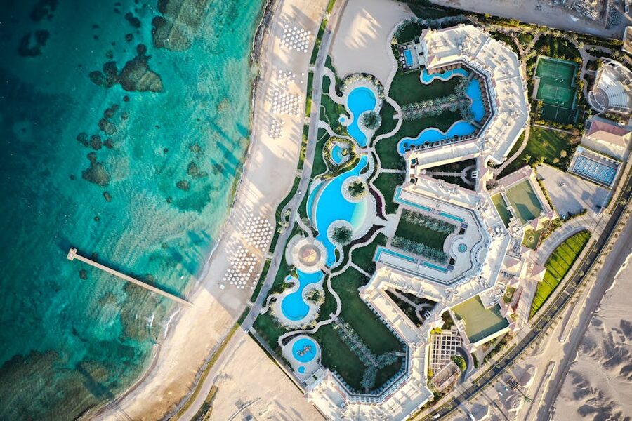 Aerial view of Hurghada resort with multiple pools swimming areas and the Red Sea beyond