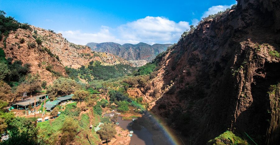 Canyon landscape with river and rainbow