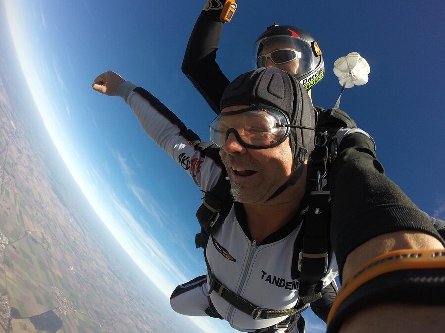 Tandem parachute extreme sport with skydivers in the air