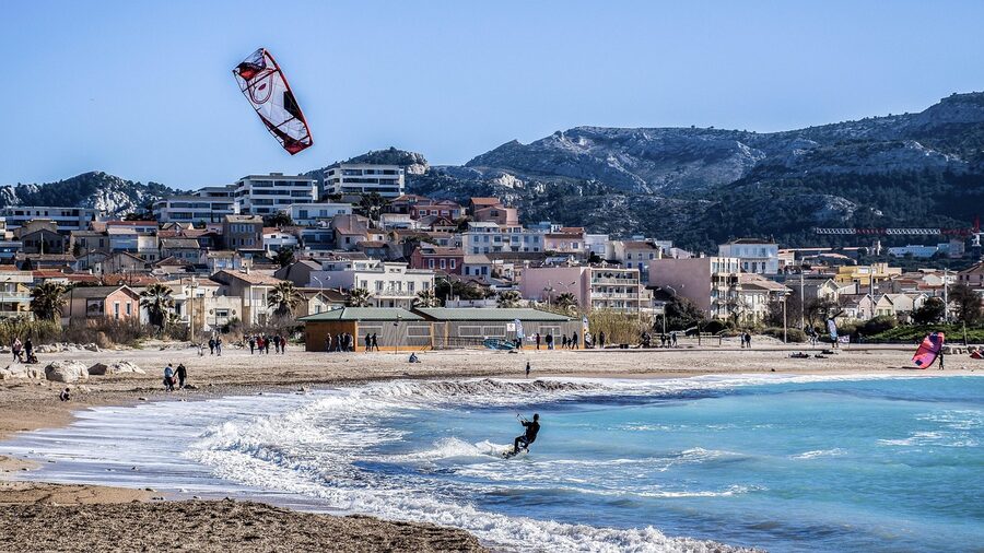 Parasailing on beach vacation with colourful parachute and blue sea