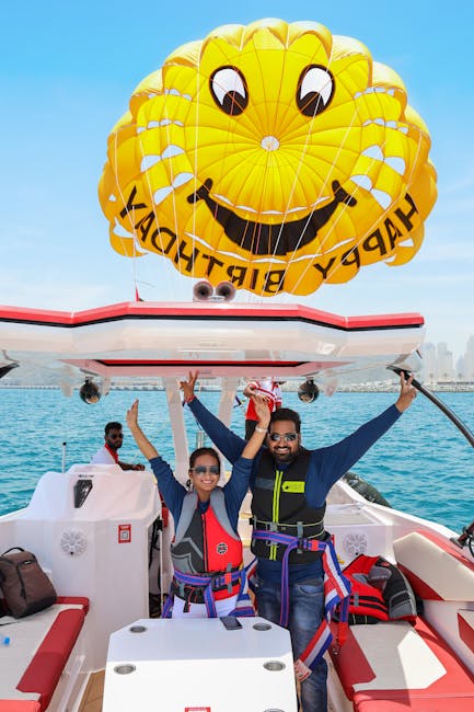 Parasailing in Dubai with smiley face parachute over blue water