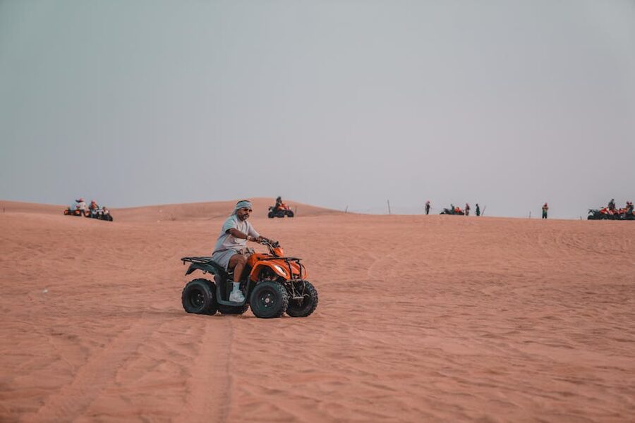 Quad biking vast desert dunes