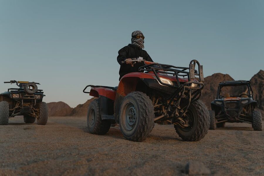 Quad bikes on rugged terrain with mountains