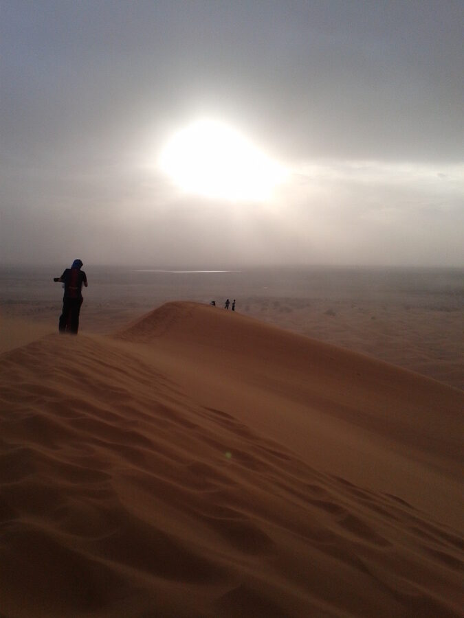 Woman on top of dune Merzouga