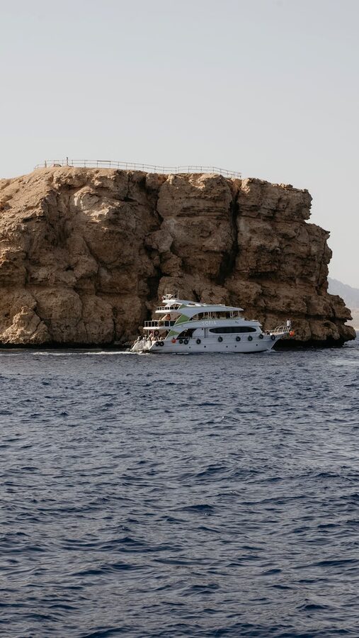 Luxury yacht sailing by cliffs in Sharm