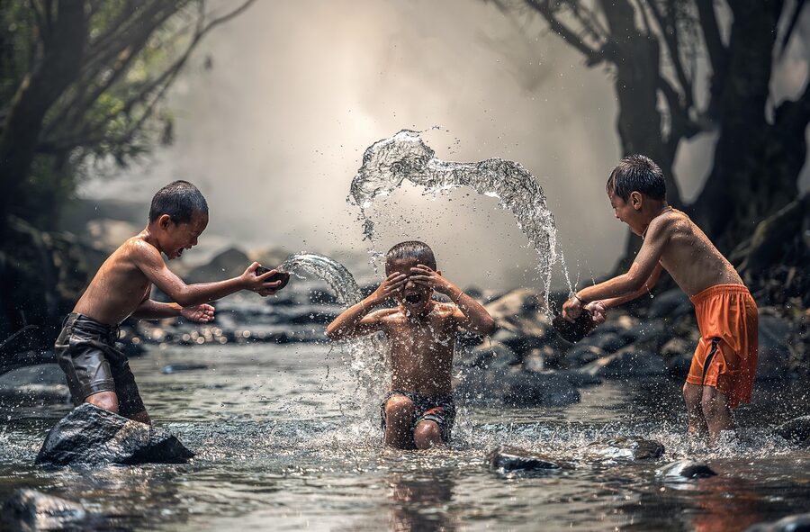 Children playing on splash pad water feature