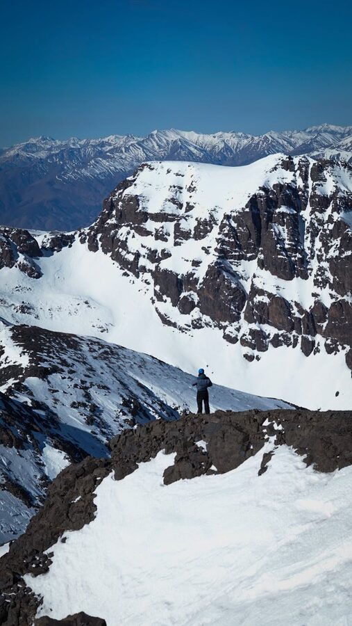 Lone explorer on snow-covered peak
