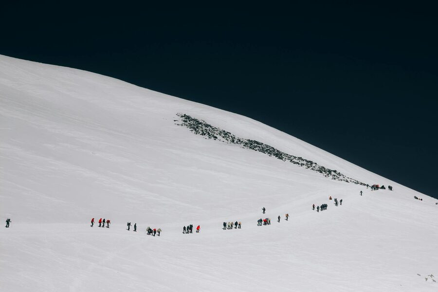 Group trekking snow-covered mountain