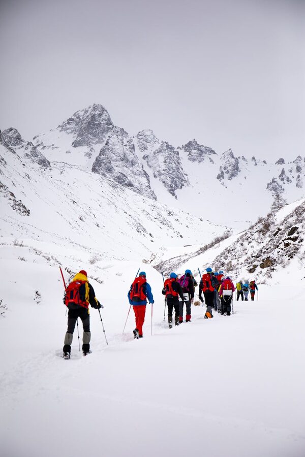 Hikers in snowy alpine mountains