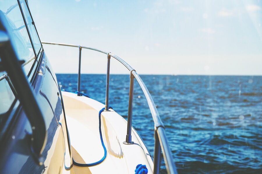 Swimming in blue ocean water from yacht platform